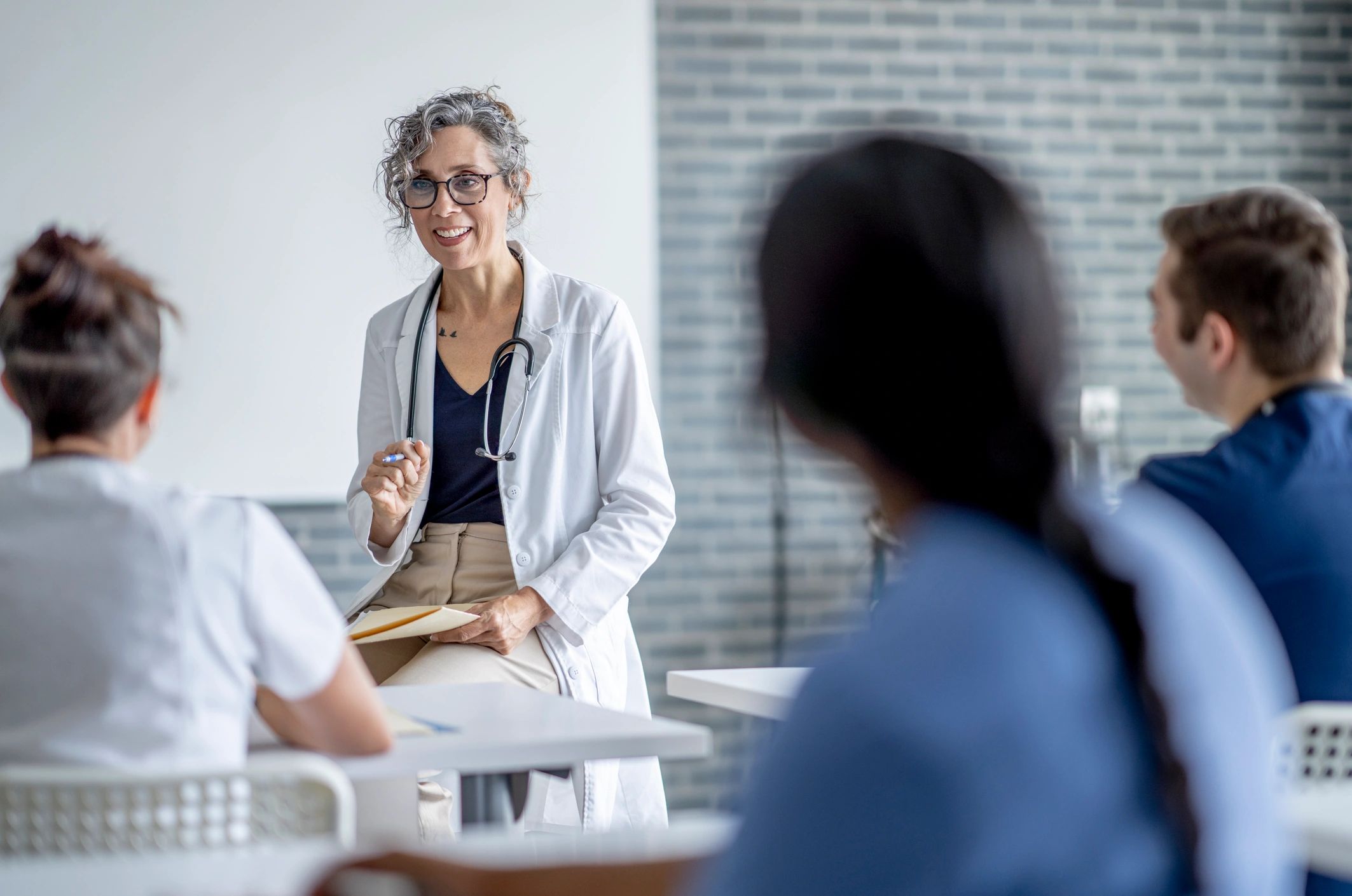 Healthcare instructor teaching a small group during a training class