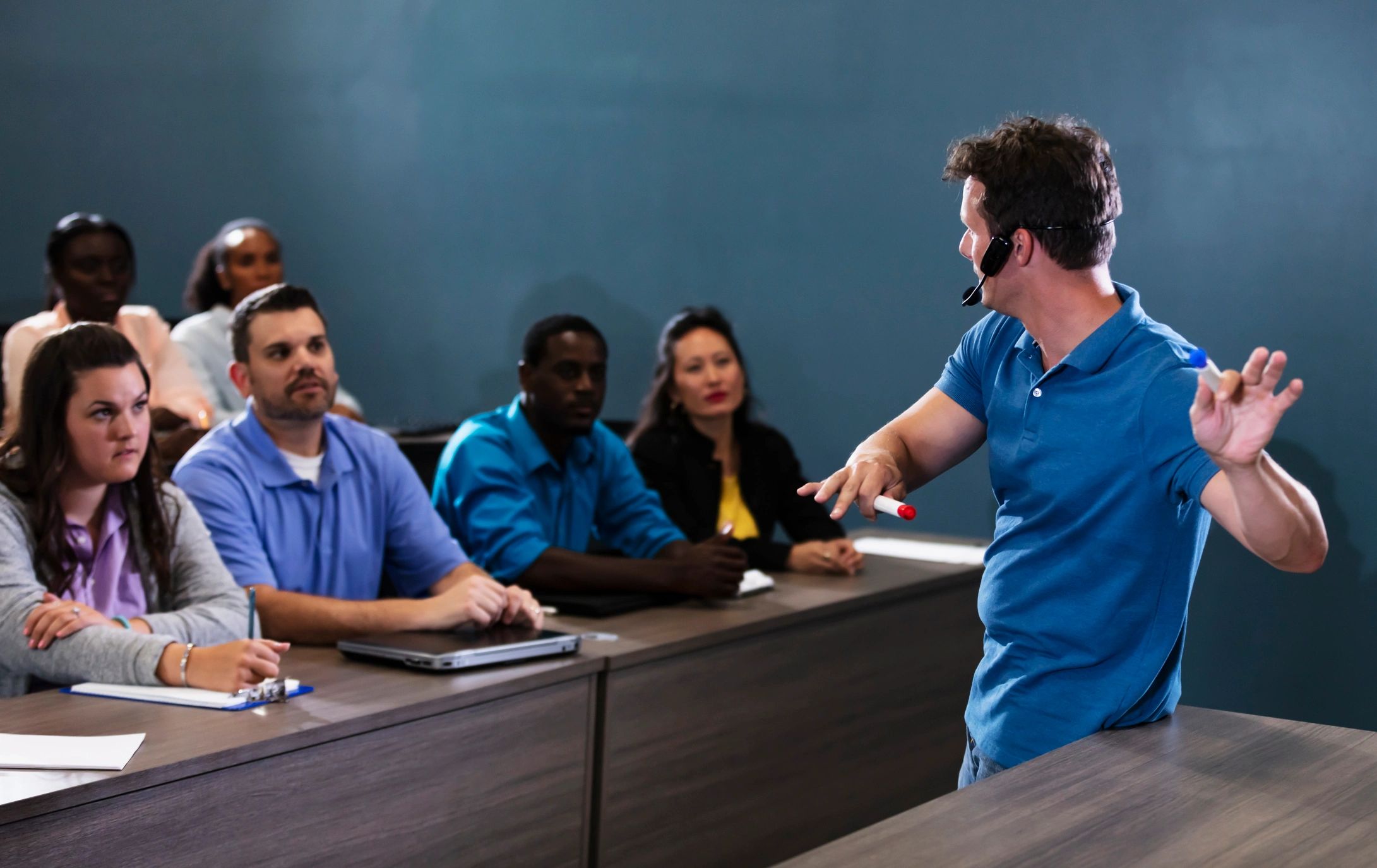 Professional instructor presenting to an adult classroom audience